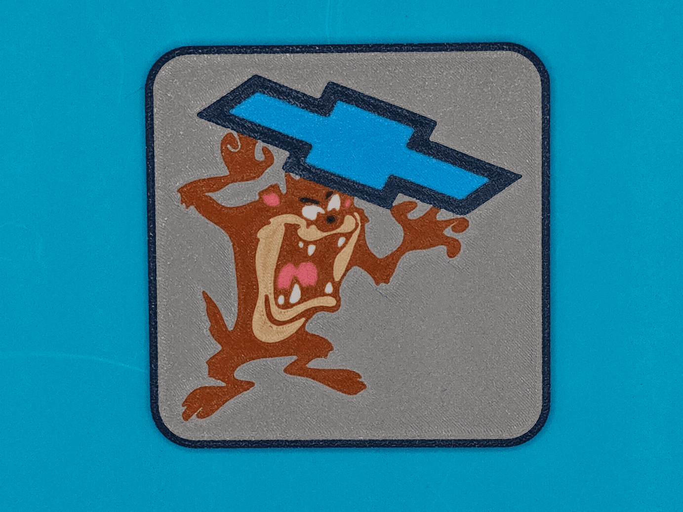 Tasmanian Devil Holding Chevrolet Emblem
