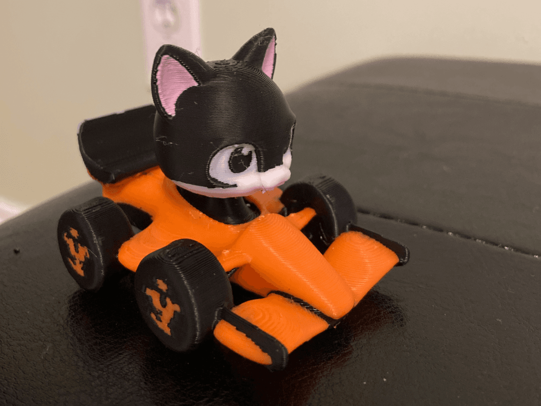 Cat driving Formula 1 McLaren car (Lando Norris)