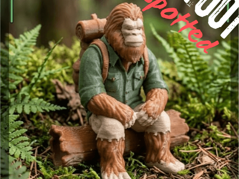Bigfoot seated on a log.