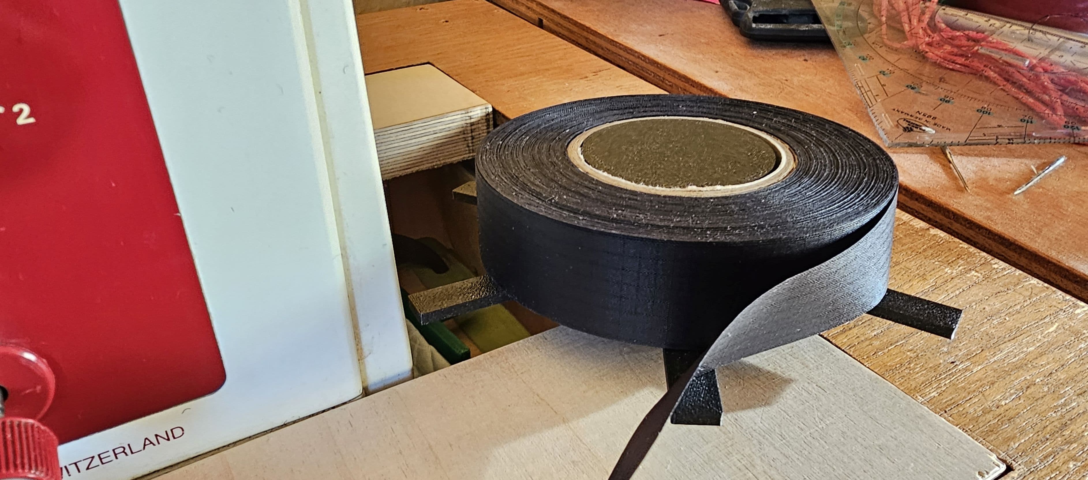 roller to feed seam tape to a sewing machine
